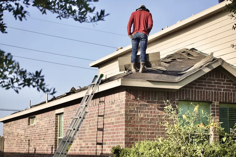 Professional roofer working on a residential roof in Home Corner